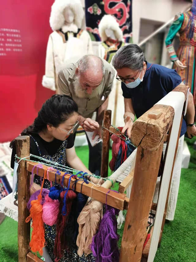 楊永良的學生在展會上向客商介紹加牙藏毯編織技藝。受訪者供圖