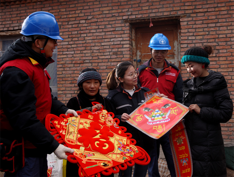 1月13日，国网青海同仁市供电公司员工为建档立卡牧民赠送中国结和春联。祁正吉摄